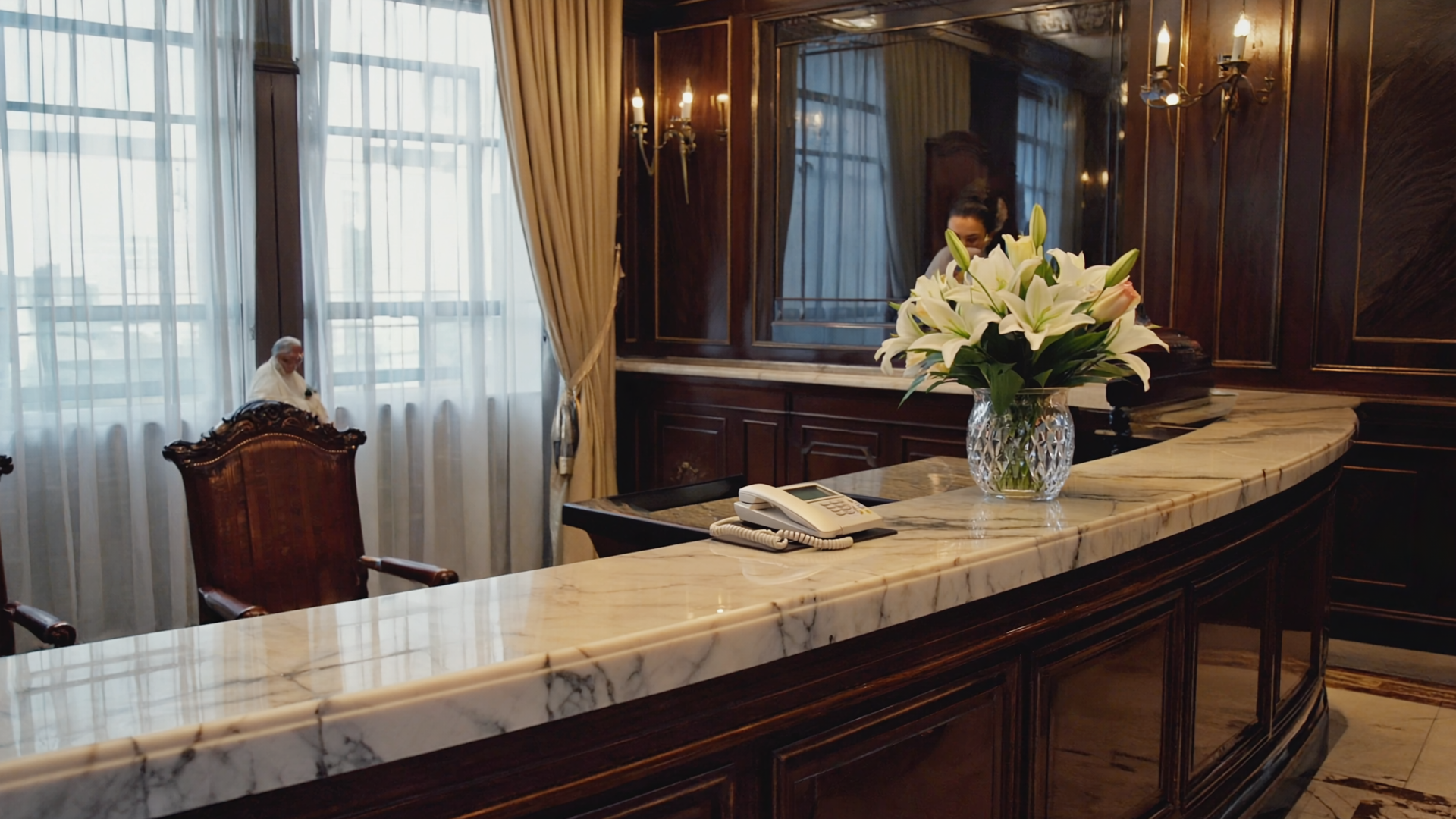 Peaceful funeral home reception lobby with warm lighting